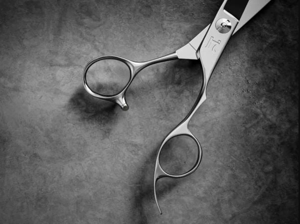 Hattori Hanzo professional hair cutting shears with offset handle design reducing thumb strain for barbers and stylists